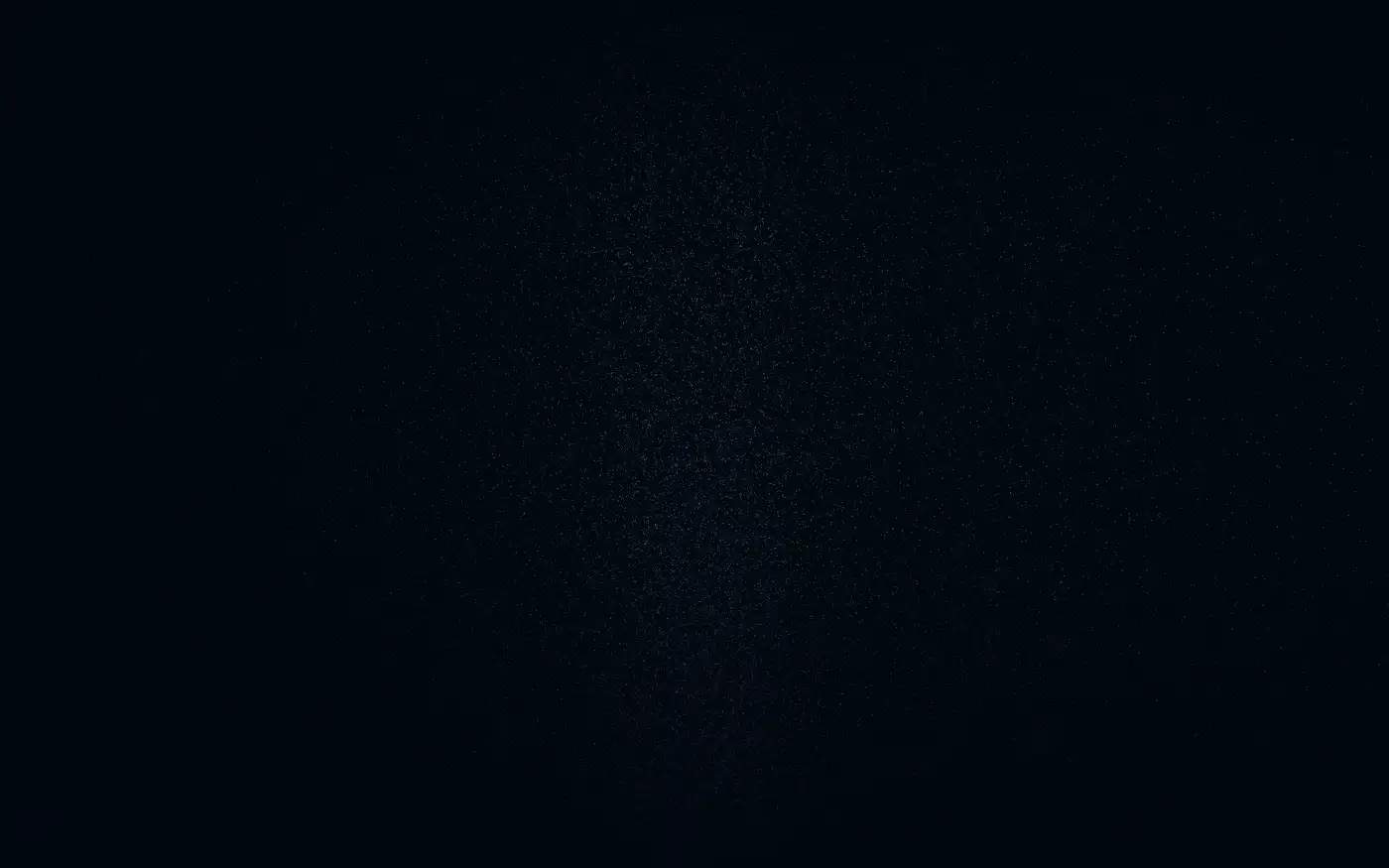A dark horizon with the faintest grain of light beneath it.