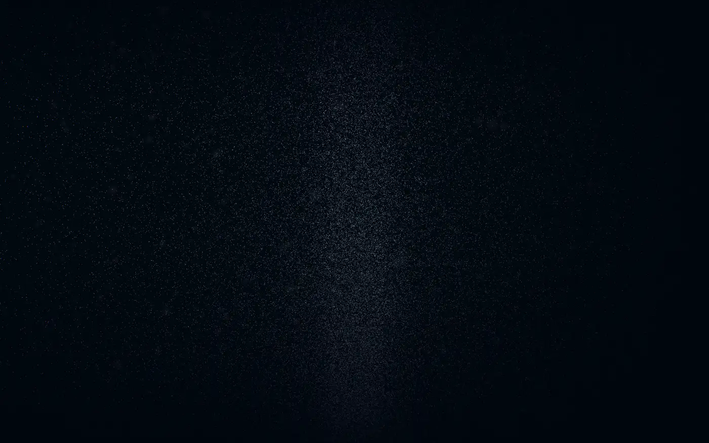 Tens of thousands of faint marks suspended in darkness, denser with depth.